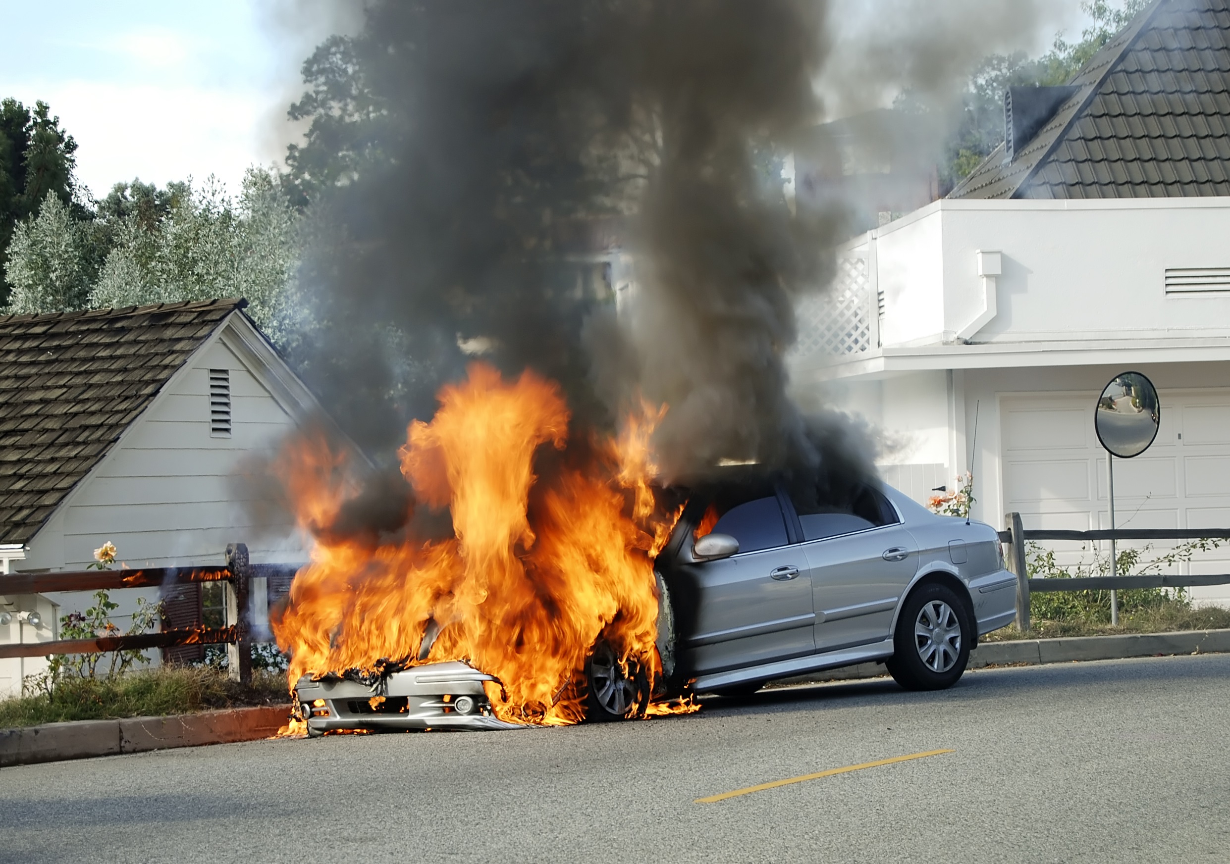 CAR ON FIRE IN FRONT OF HOME